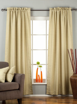 Olive green raw silk rod pocket curtains hung at a window