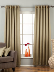Olive green sari grommet top curtains hung at a window