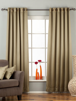 Olive green sari grommet top curtains hung at a window
