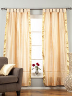 Misty rose sari tab top curtains hung at a window