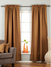 Brown raw silk rod pocket curtains hung at a window