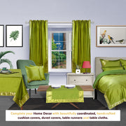 Olive green sari rod pocket curtains hung at a window