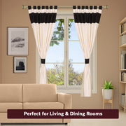 Cream raw silk tab top curtains hung at a window