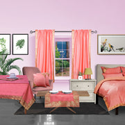 Pink sari rod pocket curtains hung at a window