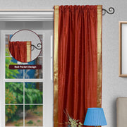 Rust sari rod pocket curtains hung at a window