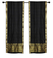 Black sari rod pocket curtains hung at a window
