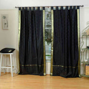 Black sari tab top curtains hung at a window