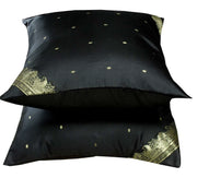 Black sari cushion covers arranged on a sofa
