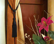 Black sari curtain tiebacks holding a panel open