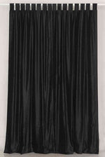 Black velvet tab top curtains hung at a window