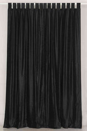 Black velvet tab top curtains hung at a window