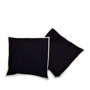 Cream raw silk cushion covers arranged on a sofa