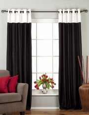 Black velvet ring top curtains hung at a window