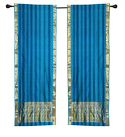 Blue sari rod pocket curtains hung at a window