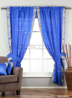 Blue sari rod pocket curtains hung at a window