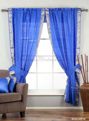Blue sari rod pocket curtains hung at a window