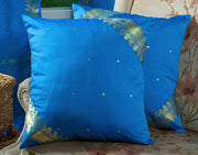 Blue sari cushion covers arranged on a sofa