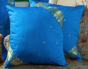 Cool blue sari cushion covers arranged on a sofa
