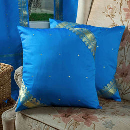 Blue sari cushion covers arranged on a sofa