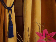 Blue sari curtain tiebacks holding a panel open