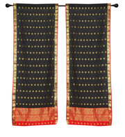 Black sari rod pocket curtains hung at a window