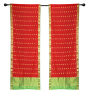 Red sari rod pocket curtains hung at a window