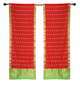 Red sari rod pocket curtains hung at a window