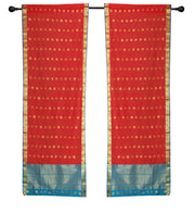 Red sari rod pocket curtains hung at a window