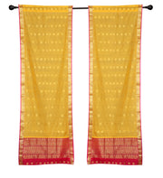 Yellow sari rod pocket curtains hung at a window