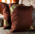 Sophisticated brown sari cushion covers arranged on a sofa