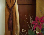 Brown sari curtain tiebacks holding a panel open