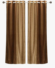 Taupe velvet ring top curtains hung at a window
