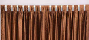 Brown velvet tab top curtains hung at a window