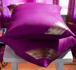 Violet sari cushion covers arranged on a sofa