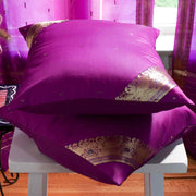 Violet sari cushion covers arranged on a sofa