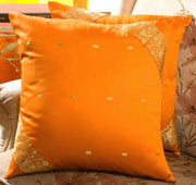 Earthy mustard sari cushion covers arranged on a sofa