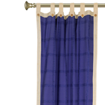 Cream sari tab top curtains hung at a window