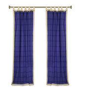 Cream sari tab top curtains hung at a window