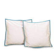 Turquoise raw silk cushion covers arranged on a sofa