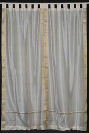 Cream sari tab top curtains hung at a window