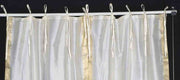 Cream sari tie top curtains hung at a window
