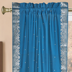 Turquoise sari rod pocket curtains hung at a window