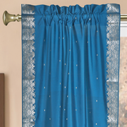 Turquoise sari rod pocket curtains hung at a window