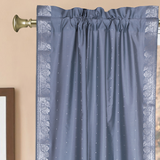 Silver sari rod pocket curtains hung at a window