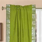 Olive green sari rod pocket curtains hung at a window