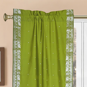 Olive green sari rod pocket curtains hung at a window