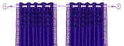 Purple sari grommet top curtains hung at a window