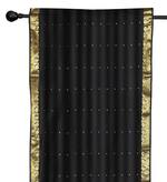 Black sari rod pocket curtains hung at a window