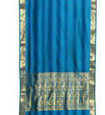 Blue sari rod pocket curtains hung at a window