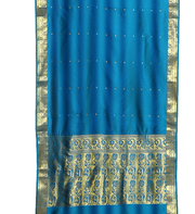 Blue sari rod pocket curtains hung at a window